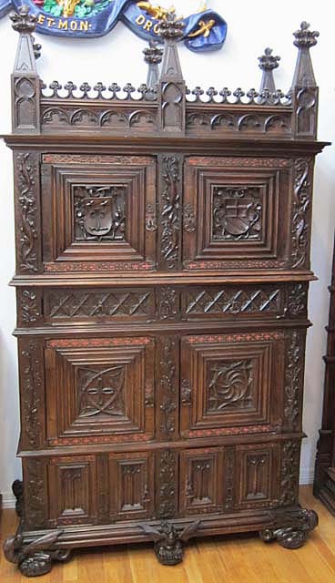french antique gothic cabinet with coats of arms and basilisks